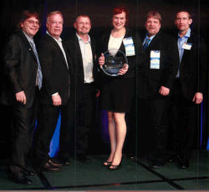 Jim Schnepper GAF Executive VP, Sales, and Paul Bromfield GAF Senior VP, Marketing, present the 2013 President's Club Award to Chad Muth, Ty Lang, Holly Colley and Kelly Wengerd on behalf of Muth & Company Roofing.